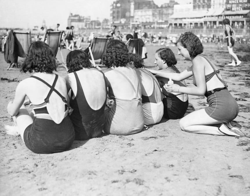 A woman applies sun cream to her friends' backs on Margate Main Sands, 1934