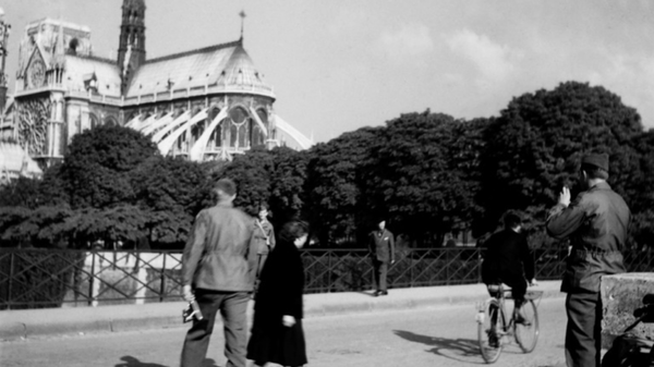 US soldiers walk and take pictures near Notre-Dame Cathedral in Paris in October 1944